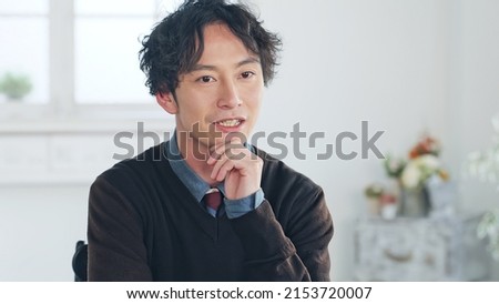Talking Asian man in the room. Video conferencing. Web meeting. Interview. Royalty-Free Stock Photo #2153720007
