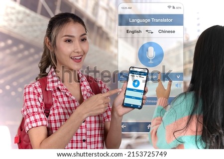 Tourist girl using mobile language translator application on smartphone to communicate to amother woman.