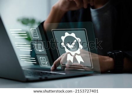 A businessman operating with the quality assurance, guarantee, standards, ISO certification, and standardization notion as a proof of top service. Royalty-Free Stock Photo #2153727401