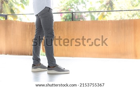 Gray men's fabric chinos, close-up, background for a banner. Royalty-Free Stock Photo #2153755367