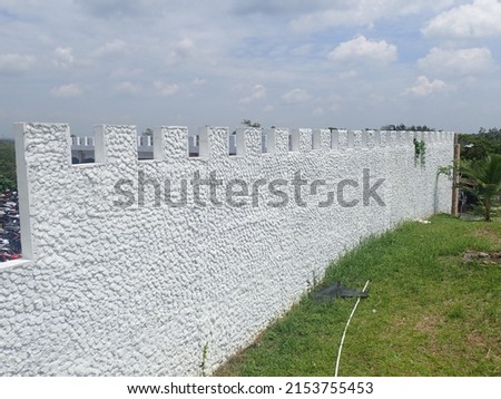white paint fort walls of natural stone