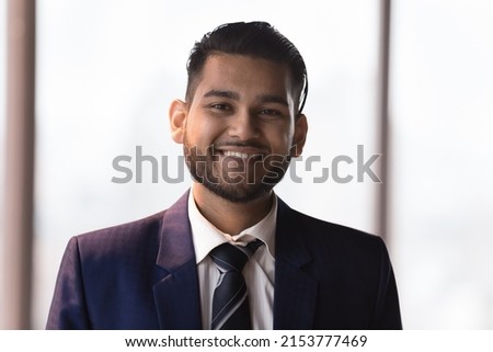Happy young millennial Indian businessman in formal suit head shot portrait. Confident ambitious CEO, executive, startup leader, manager looking at camera, smiling. Business leadership concept