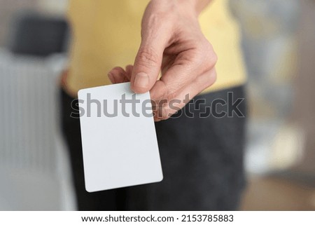 Hand holding blank business card high angle 