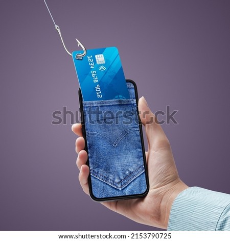 Phishing and cyber security: hacker stealing a user's credit card information on a smartphone Royalty-Free Stock Photo #2153790725
