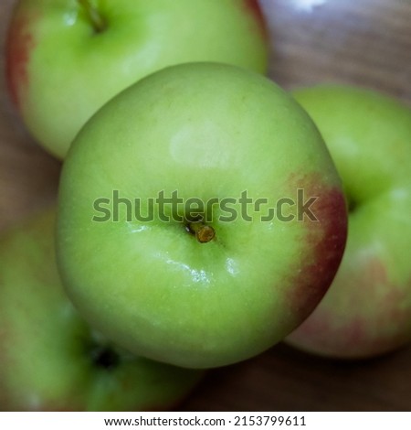 A few red-sided apples, a close-up shot. Juicy fruits.