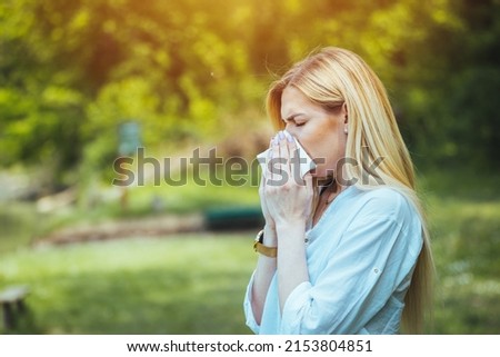 Woman Blowing Her Nose With Handkerchief In Public Parkf. Seasonal Virus Infection. Chronic Disease Control, Allergy Induced Asthma Remedy And Chronic Pulmonary Disease Concept. Royalty-Free Stock Photo #2153804851