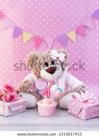 Happy 4th Birthday Card Image, teddy bear with pink cupcake, with pink number 4 candle, and pink wrapped presents against a pink background 