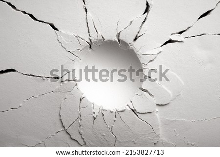 White powder surface with cracks and a round crater. Crater in black and white. Royalty-Free Stock Photo #2153827713