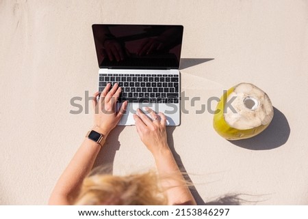Woman working with laptop computer on the tropical beach, view from above Royalty-Free Stock Photo #2153846297