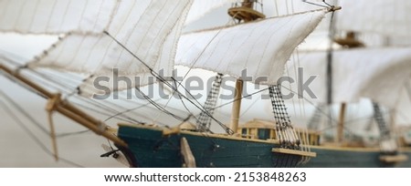 Antiquarian wooden scale model of the clipper tall ship, close-up. Traditional craft, souvenirs, hobby, collecting, vintage, modeling. Zero waste concept. Graphic resources, macro photography