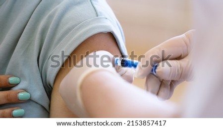Medical Clinic Closeup Vaccination Against Covid-19 Vaccination Cabinet Vaccine Medicine Health care Hospital Doctor Nurse Hand Syringe Ampoule Needle Sterile Shoulder Patient Pandemic