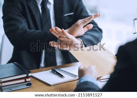 Lawyer refuses to accept bribe from business people in contracting. Corruption and anti bribery concept. Royalty-Free Stock Photo #2153891527