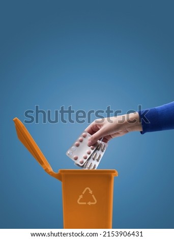 Woman putting blister packs and expired medicines in the trash bin, safe disposal of expired medications Royalty-Free Stock Photo #2153906431