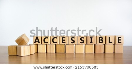 Accessible symbol. The word accessible on wooden cubes. Beautiful wooden table, white background. Business and accessible concept. Copy space.