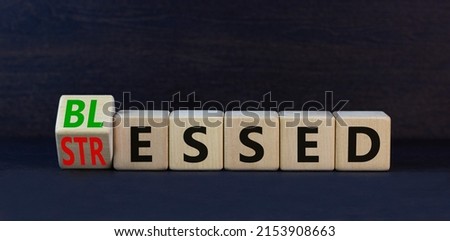 Blessed or stressed symbol. Turned wooden cubes and changed the concept word Stressed to Blessed. Beautiful black table black background. Business blessed or stressed concept. Copy space.