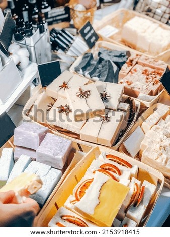 Handmade craft natural soap bars in beauty shop. Eco friendly sustainable self care products shopping on local market. Side view Royalty-Free Stock Photo #2153918415