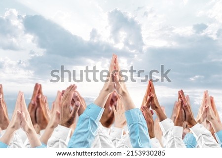 Hands in prayer against the sky. Dlured background. The concept of religious beliefs, confessions, worship. Royalty-Free Stock Photo #2153930285