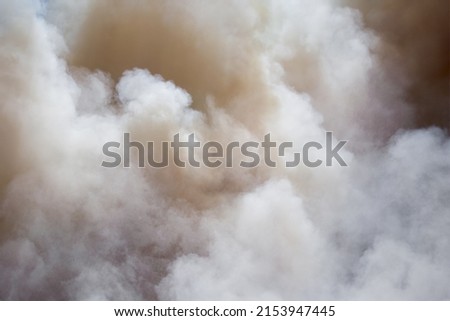 Grey clouds of smoke from the fire
