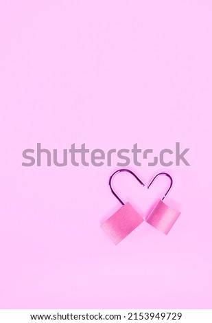 Two opened padlock in heart shape on pink background , passion and love