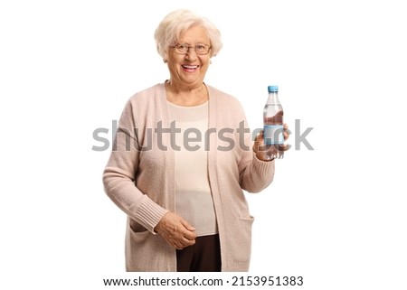 Elderly woman holding a plastic bottle of water and smiling isolated on white background