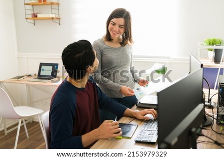 Beautiful woman smiling and speaking with his boyfriend while both working remotely from home as a designers