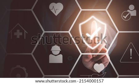 Work safety concept. Businessman touching check mark in shield icon. Safety first sign on virtual screen. Hazards, protections, regulations and insurance, Zero accidents. Royalty-Free Stock Photo #2154000157