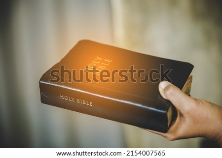 Christian woman holds bible in her hands. Concept for faith, spirituality and religion. Peace, hope. Royalty-Free Stock Photo #2154007565