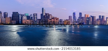 Asphalt road and city skyline with modern commercial buildings in Hangzhou at night, China. Royalty-Free Stock Photo #2154013185