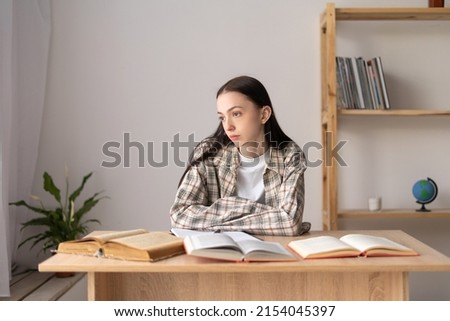 Stressed asian college student tired of hard studying with books while preparing for exams, overworked high school student exhausted from hard study and amount of homework, study troubles concept