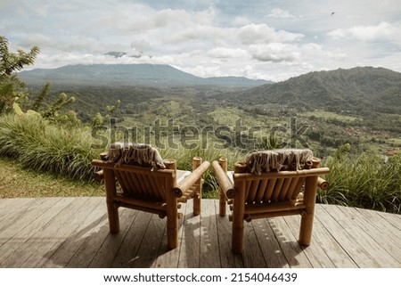 Bamboo chairs with great mountain or volcano views. Bamboo house in Bali.