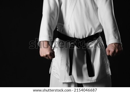 Man in karategi on black background Royalty-Free Stock Photo #2154046687