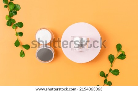Top view of cosmetic bottle cream mockup, Blank label package on orange background.	