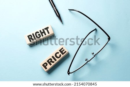 RIGHT PRICE text on wooden block ,blue background