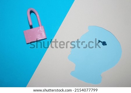 locked padlock on a blue background, a key in a pastel blue paper head on a cream background, the solution to every problem is in our mind