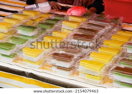Selective focus picture of "kue talam" packed in plastic packaging sell at the stall. Famous bite-sized snack for Malaysian during tea time.