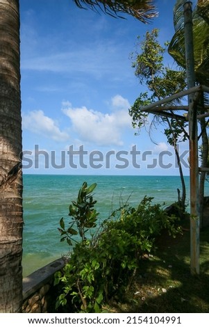 View of Anyer beach in the morning, seen from villa patra, blue sea, blue sky with coconut tree