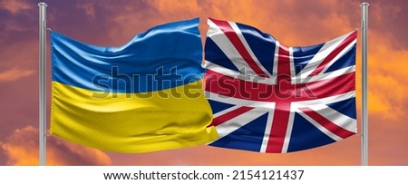 Ukraine and United Kingdom two flags on flagpoles and blue sky. military help to ukraine Royalty-Free Stock Photo #2154121437