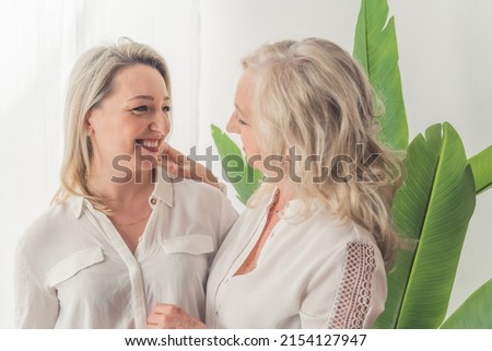 Lovely photo of mom and daughter talking to each other and sharing some news, horizontal shot. High quality photo