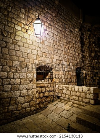 Beautiful landscape located in Old town Dubrovnik, Croatia. Stone fortress and lighting lantern. Summer destination. Tourism. Night view.