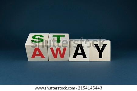 Stay - away. Cubes form the words Stay or Away. The concept of social problems and lifestyle Royalty-Free Stock Photo #2154145443