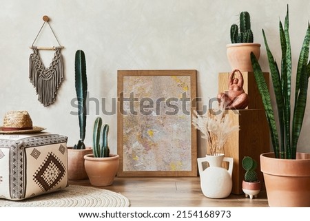 Creative composition of stylish living room interior with mock up poster frame, cacti and personal boho accessories. Plant love and nature concept. Template.