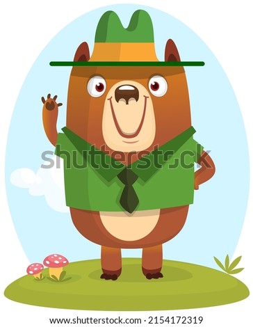Cartoon funny bear scout ranger wearing green hat standing on the summer meadow. Vector illustration