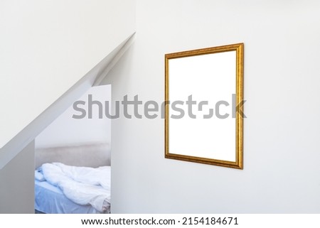 Mockup for painting in golden picture hanging on hotel room wall with copy space