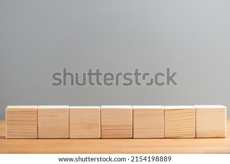 Blank wooden block cubes on a gray background for your text and advertisement. Free space for business concept template and banner..