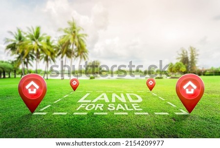Land plot management - real estate concept with a vacant land on a green field available for building construction and housing subdivision in a residential area for sale, rent, buy or investment. Royalty-Free Stock Photo #2154209977