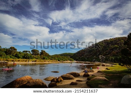 Tidal River at Wilson Promontory with autumn maple tree and blue cloudy sky view, people playing in the water Royalty-Free Stock Photo #2154211637