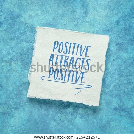 positive attracts positive - law of attraction concept - inspirational note on a handmade paper Royalty-Free Stock Photo #2154212571
