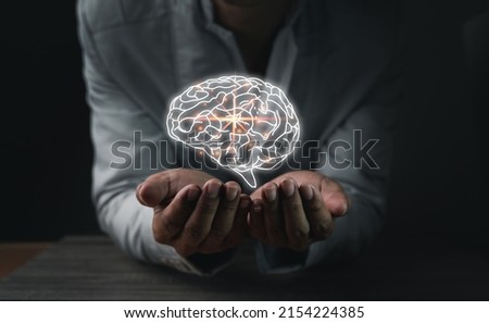 Close up of businessman's hand holding the brain in the palm, Virtual reality man with symbol neurons in the brain. Concept of idea and innovation, copy space. Royalty-Free Stock Photo #2154224385