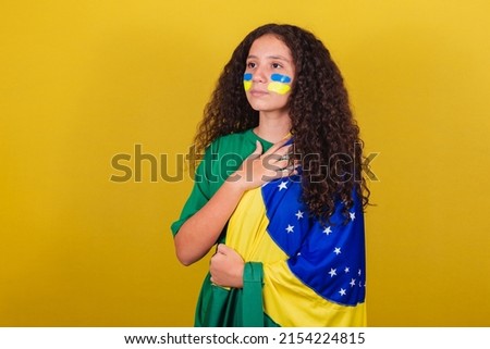 Brazilian, Caucasian girl, soccer fan, Singing national anthem. Nationalism.