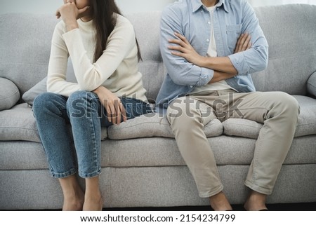 Family problems, Asian women cover her face and sit separately from husband feel disappointed after quarrels at home. Royalty-Free Stock Photo #2154234799